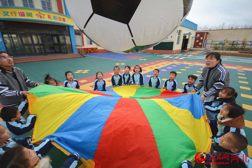 河北省邯郸市邯山区北张庄中心幼儿园孩子们和老师在参加“足球嘉年华”趣味活动。李昊摄