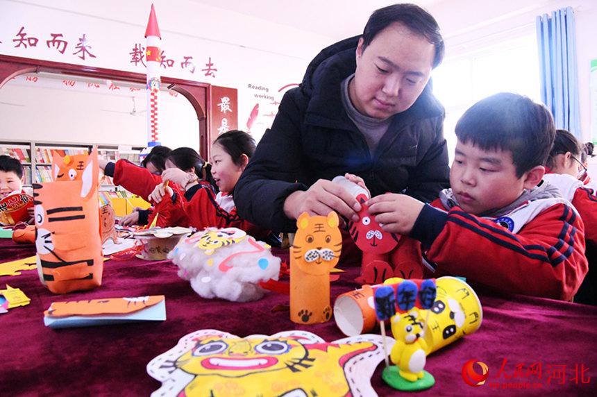 河北省邯鄲市廣平縣濱河小學學生在制作生肖虎手工。 程學虎攝