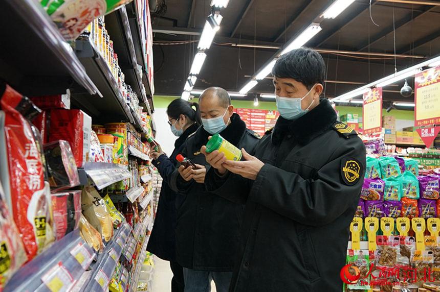 河北省巨鹿县一家超市内市场监督管理局工作人员检查产品的生产日期。 石莹莹摄