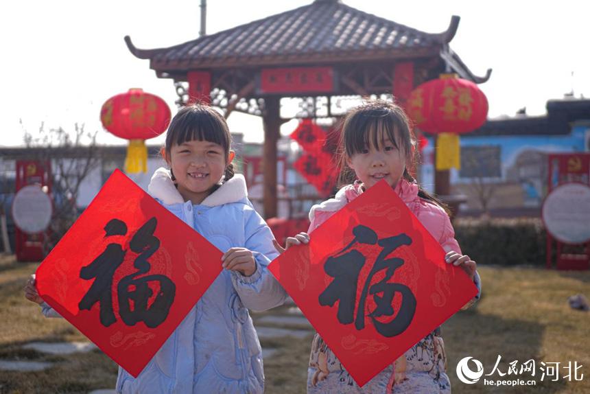 河北省唐山市丰南区胥各庄镇岭子上村的小朋友手拿福字,欢喜过年。 崔光摄