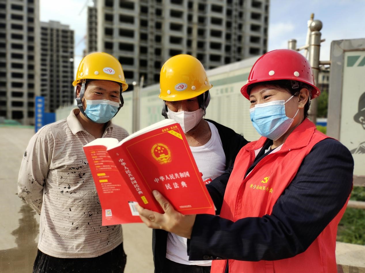 宣讲人员（右一）走进东光县各施工单位讲解《民法典》。 张金元摄