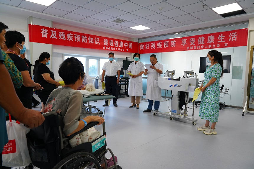 曲阳县残联工作人员为病患讲述预防残疾相关知识。 高问摄