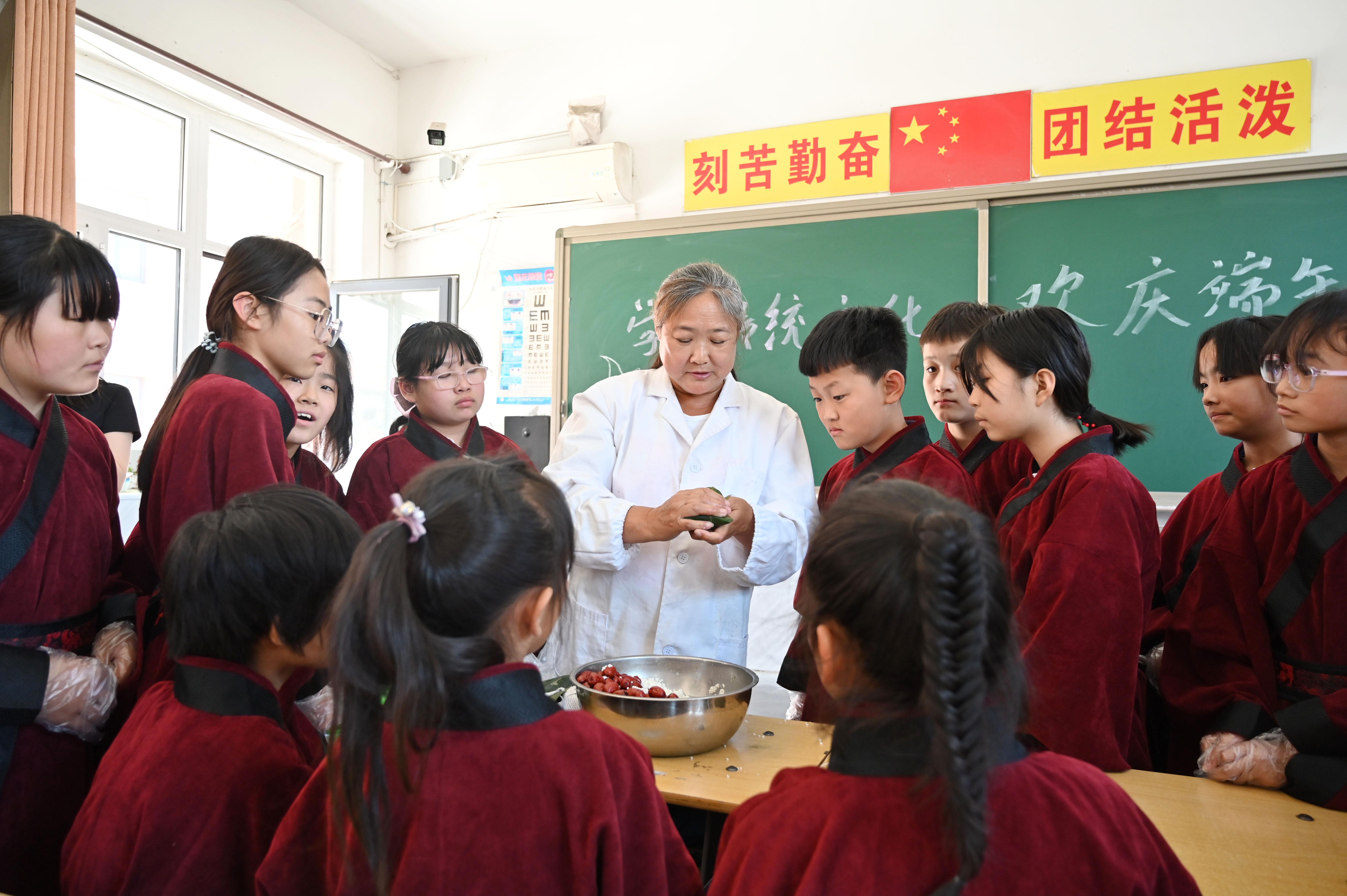 老师教学生们包粽子。 刘蒙蒙摄
