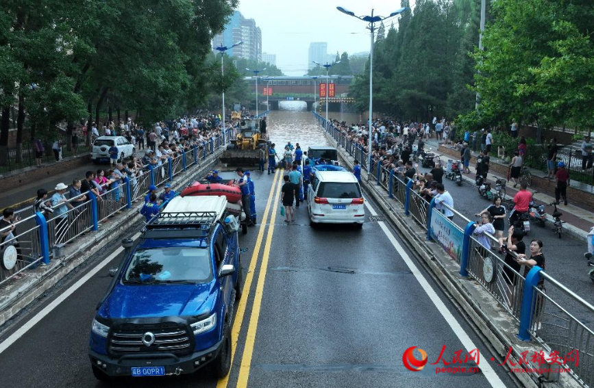 8月1日下午,在涿州市范阳路地道桥附近,水势逐渐上涨,救援人员正在准备涉水进入灾区。 人民网 李兆民摄