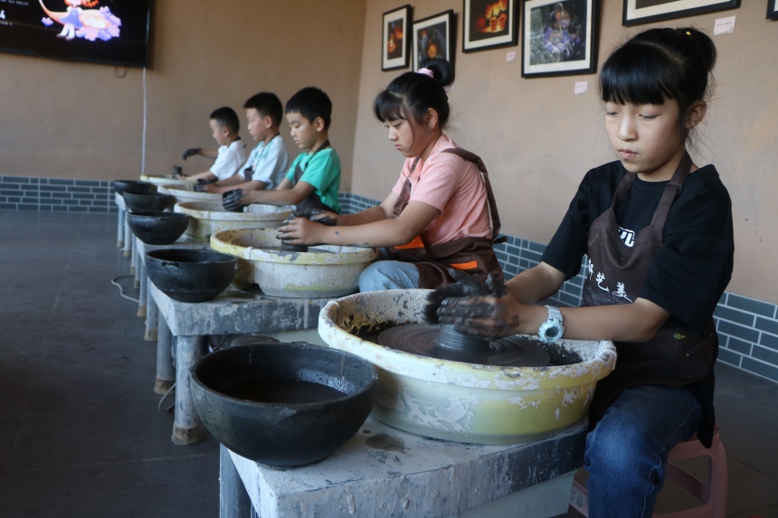 青少年们在河北省蔚县南留庄镇白河东村青砂器生产基地参观体验青砂文化 。 蔺媛媛摄