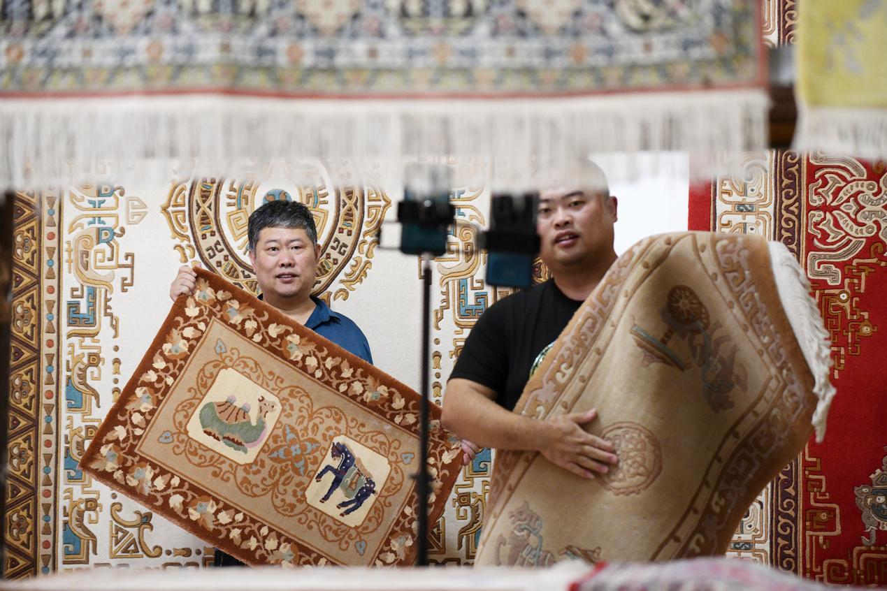 在文安县孙氏镇一家宫毯制作工坊，宫毯织造技艺非遗传承人通过直播方式销售宫毯。 高丹钰摄