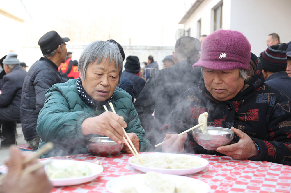 村民在品嘗餃子。 焦洛攝