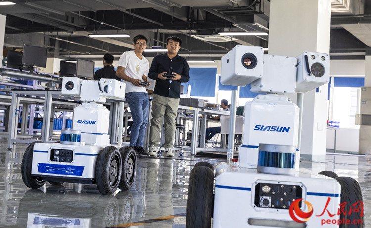天津新鬆智能科技有限公司工作人員在調試機器人。人民網記者 孫翼飛攝
