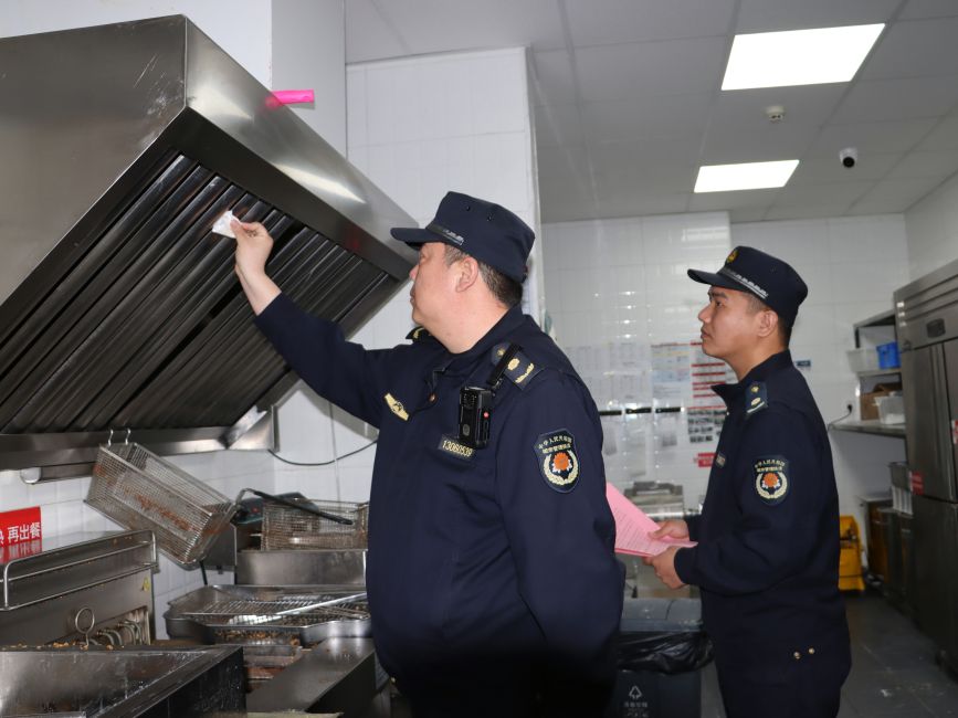 检查人员检查餐饮单位集气罩清洗情况。齐东青摄