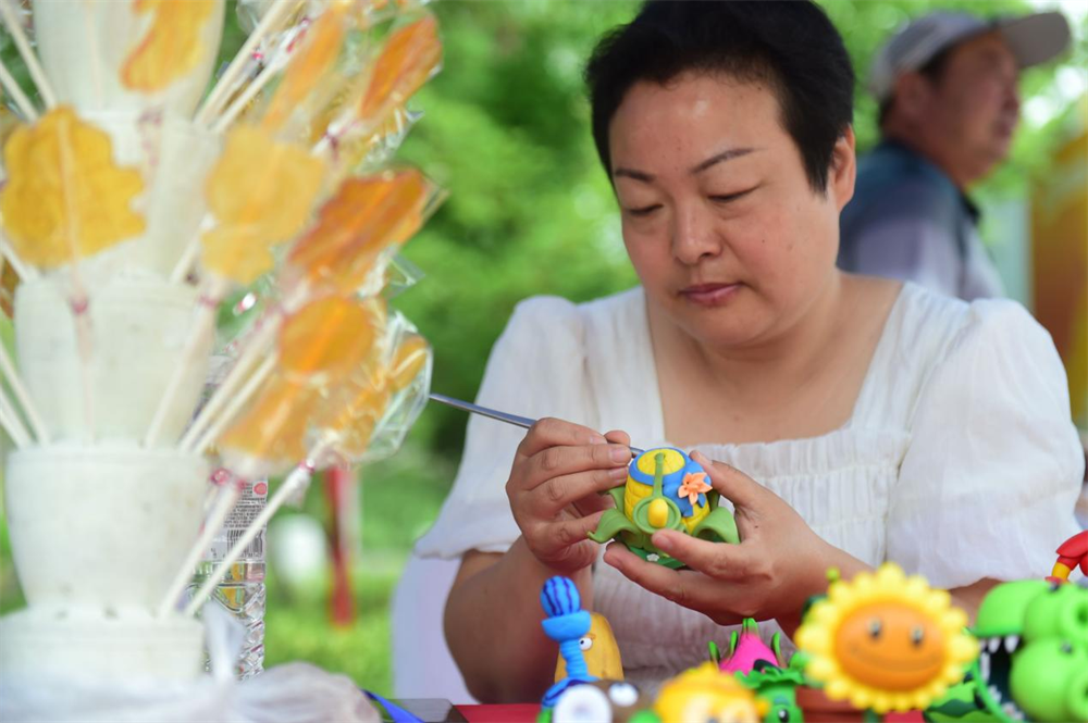 6月2日,沧州市新华区的张英英在活动现场制作面塑作品。傅新春摄