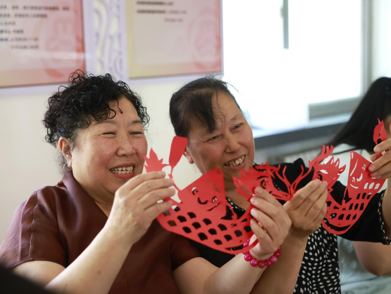 沧州市新华区欣怡社区，居民欢聚一堂，做剪纸、赏民俗。杨晨摄