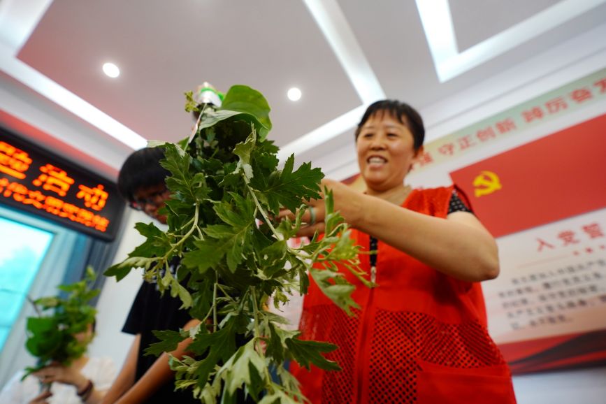 社区志愿者正在扎艾草花束。侯亚婷摄