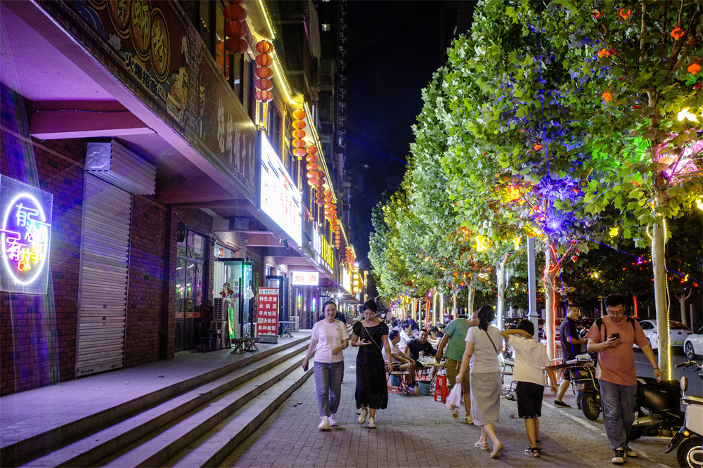 河北省邯郸市复兴区胜利桥街道大乘美食街，市民在这里品尝美食、感受成语墙的文化魅力。聂长青摄