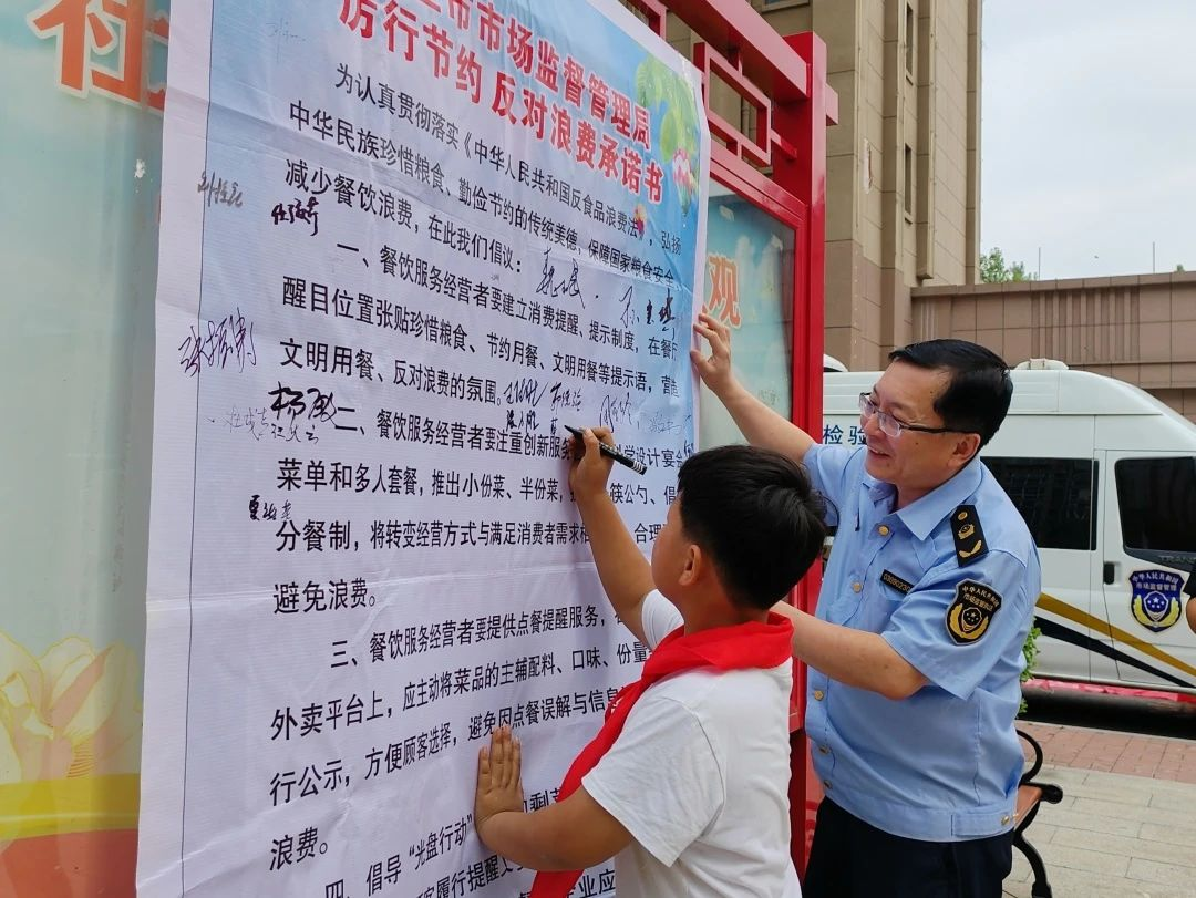 社區小朋友在“厲行節約 反對浪費承諾書”上簽字。方園園攝
