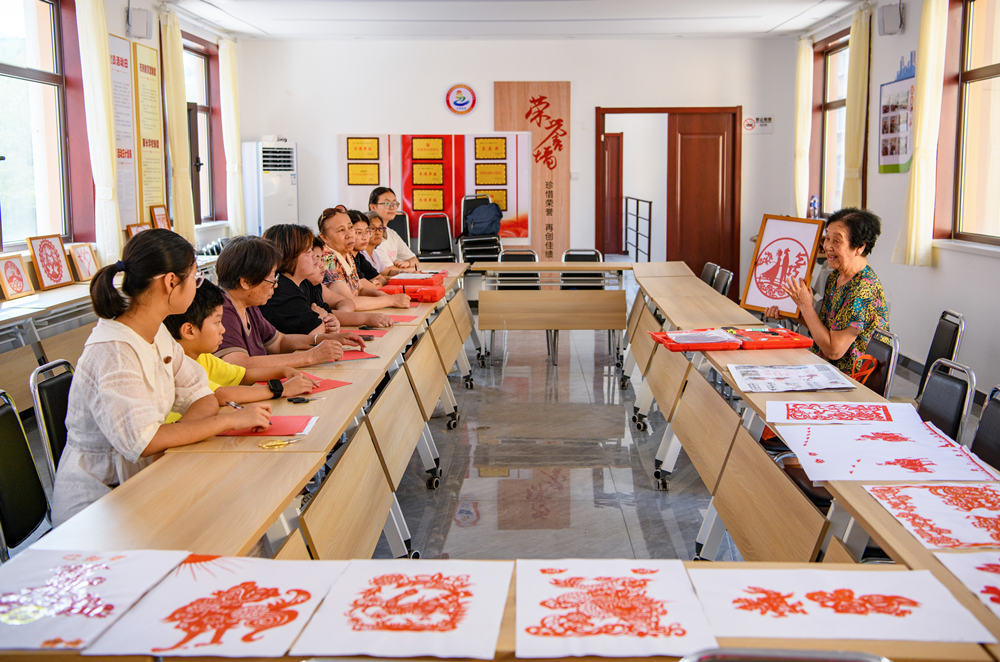 李秀贞老人展示她的剪纸作品。张明骏摄