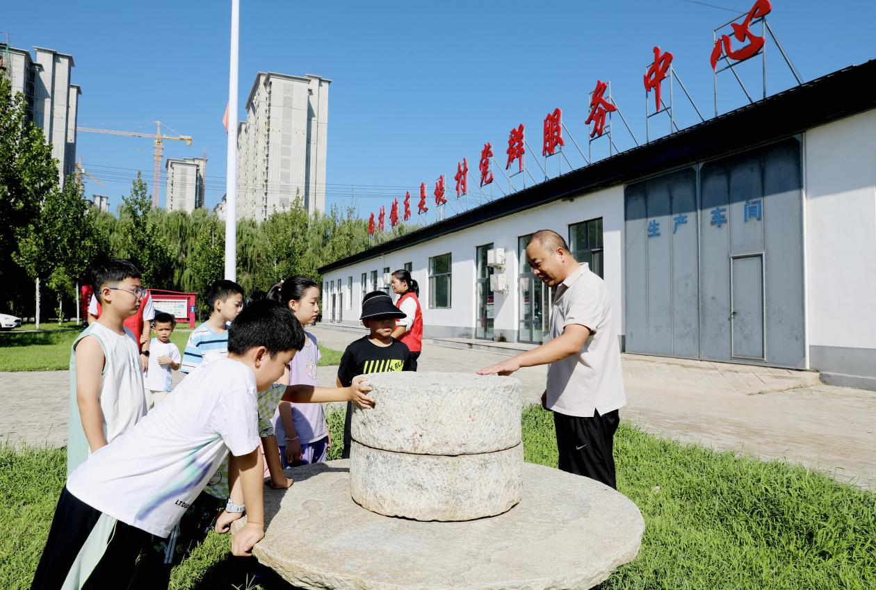 学生在东是堤村了解传统农具。刘巨雷摄