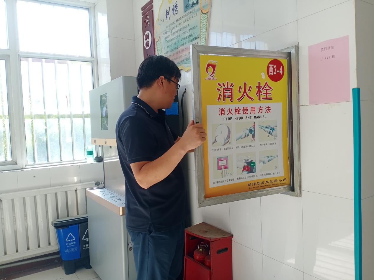 鸡泽县第二实验小学教师正在排查校园安全隐患。贾丽沙摄