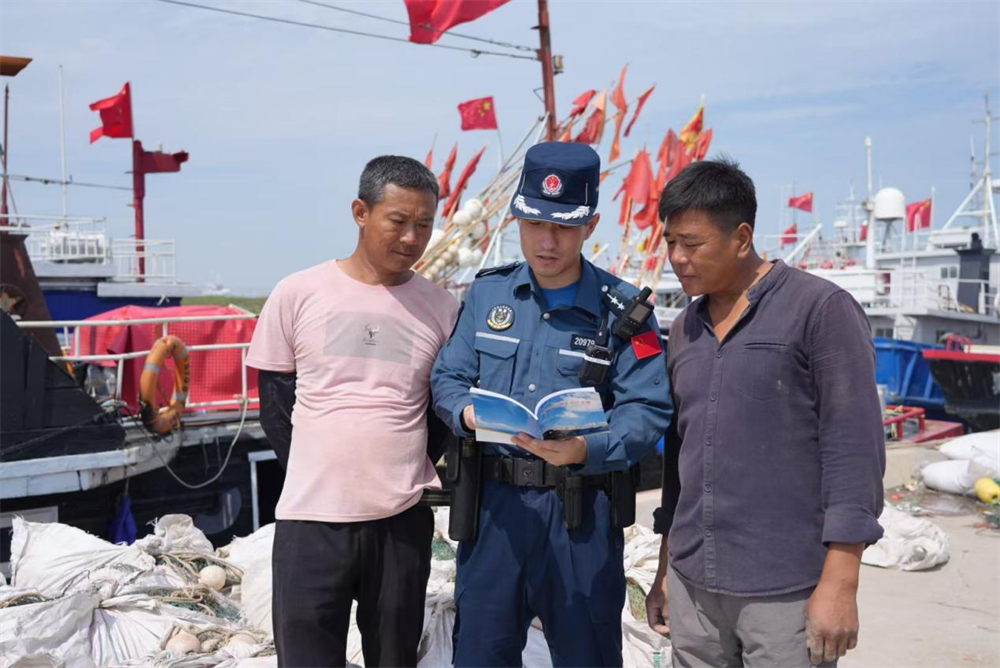 唐山海警局执法员对渔民进行开展海上安全生产作业教育。李福政摄