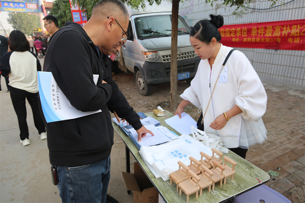 10月12日，居民了解“以旧换新”政策。李继业摄