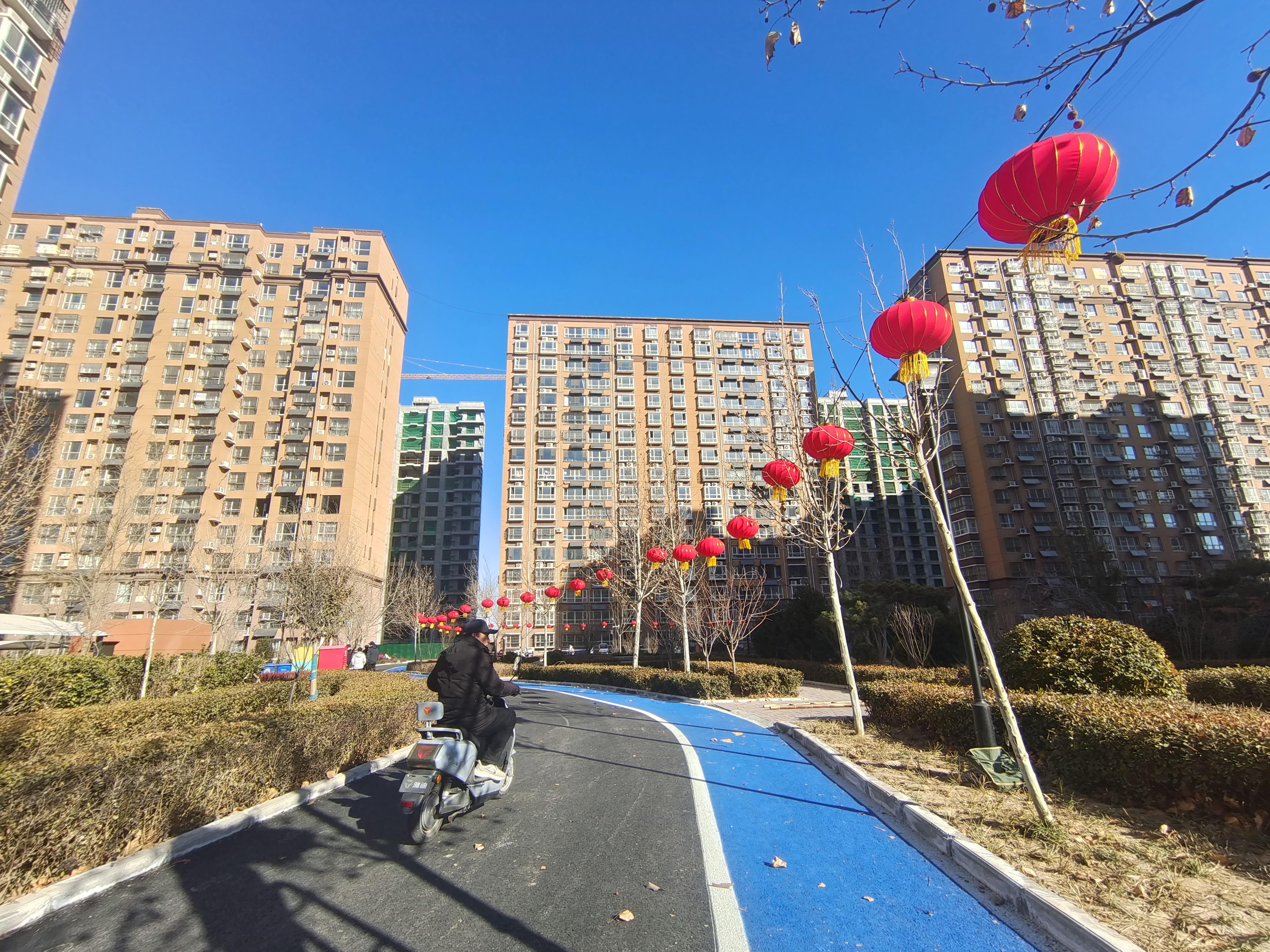 小区道路全部铺上了沥青，大红灯笼高高挂起。霍飞飞摄