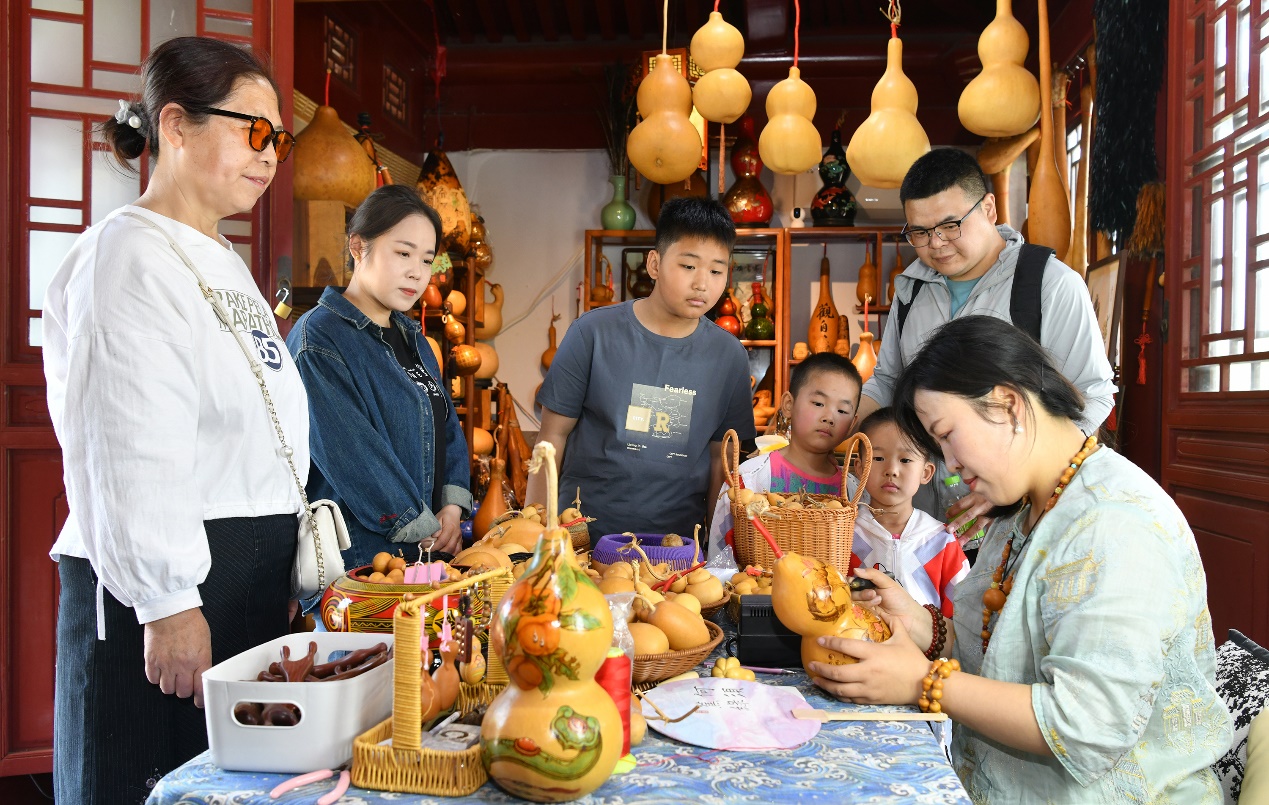 在沧州园博园，葫芦烙画艺人在给游客展示葫芦烙画技艺。苑立伟摄