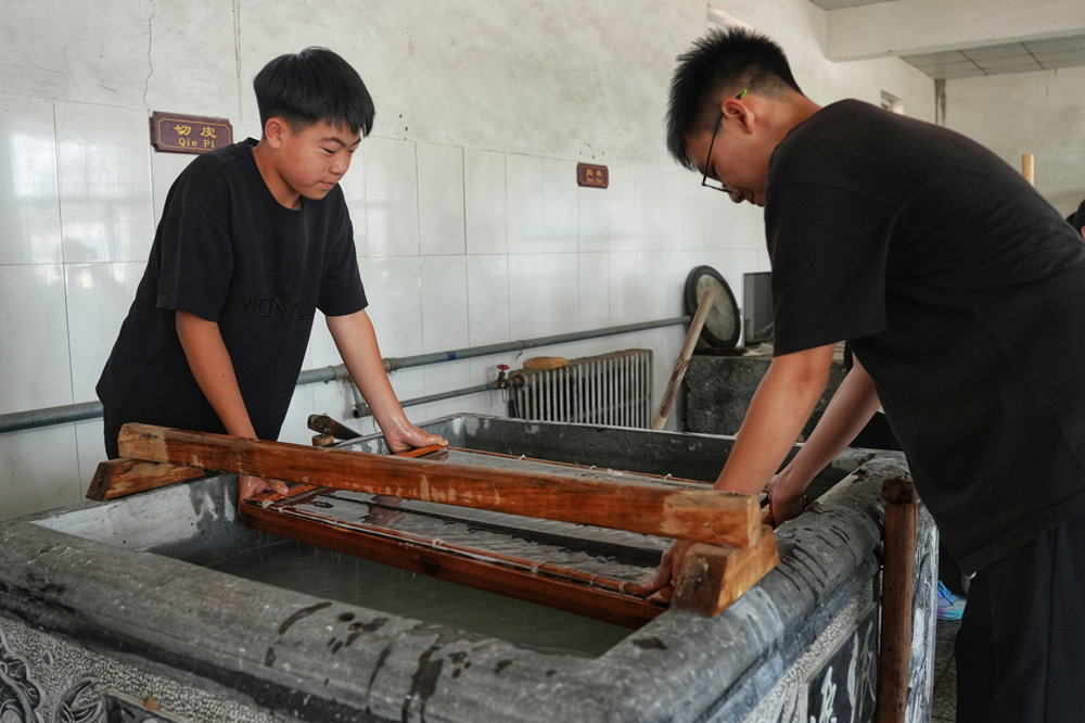 近日，迁安市阎家店镇完全小学学生正在体验手工造纸抄纸工序。张泽慧摄