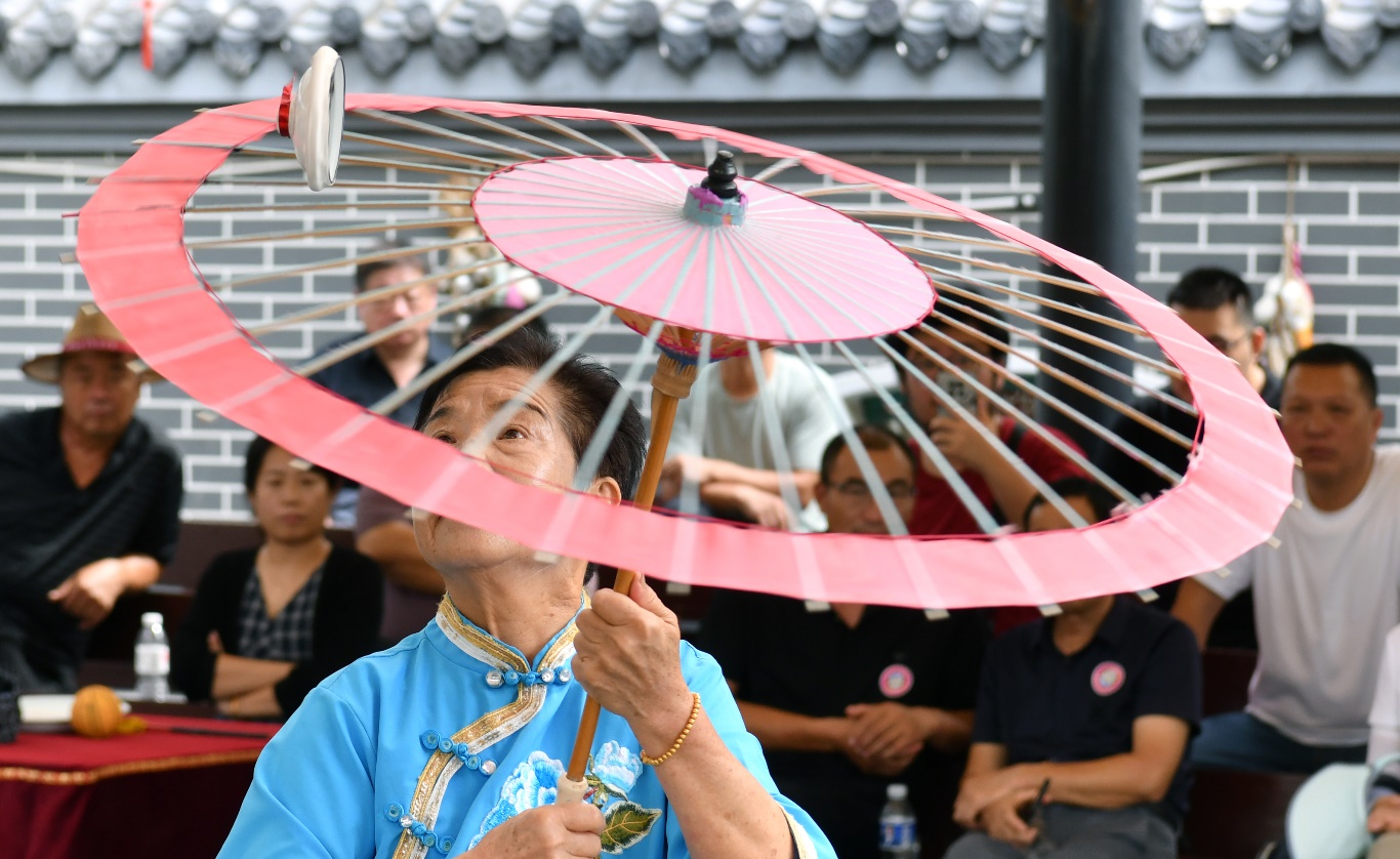 9月4日，杂技艺人在吴桥杂技大世界为游客表演《转伞》。苑立伟摄