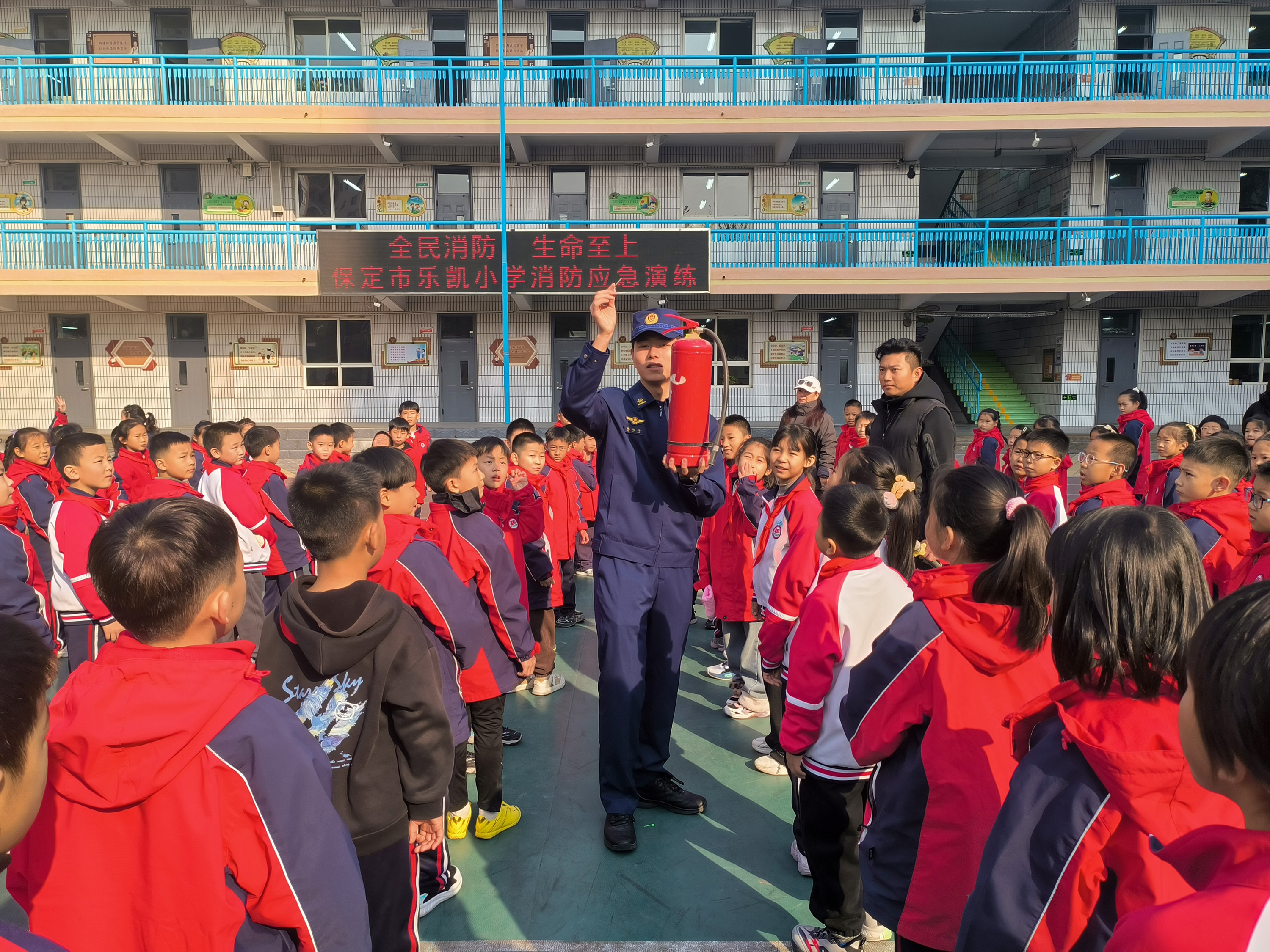 在保定市乐凯小学，消防宣传员为学生讲解灭火器的使用方法。魏宇彤摄