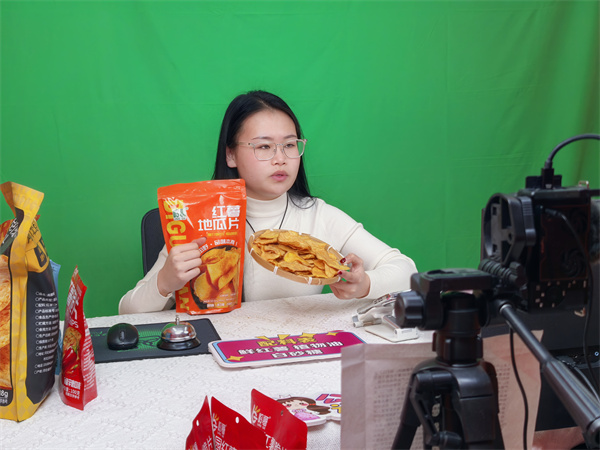 在鸡泽县岭哥食品的直播间里，主播正热情地向全国网友推介本地生产的薯片。 魏晓摄