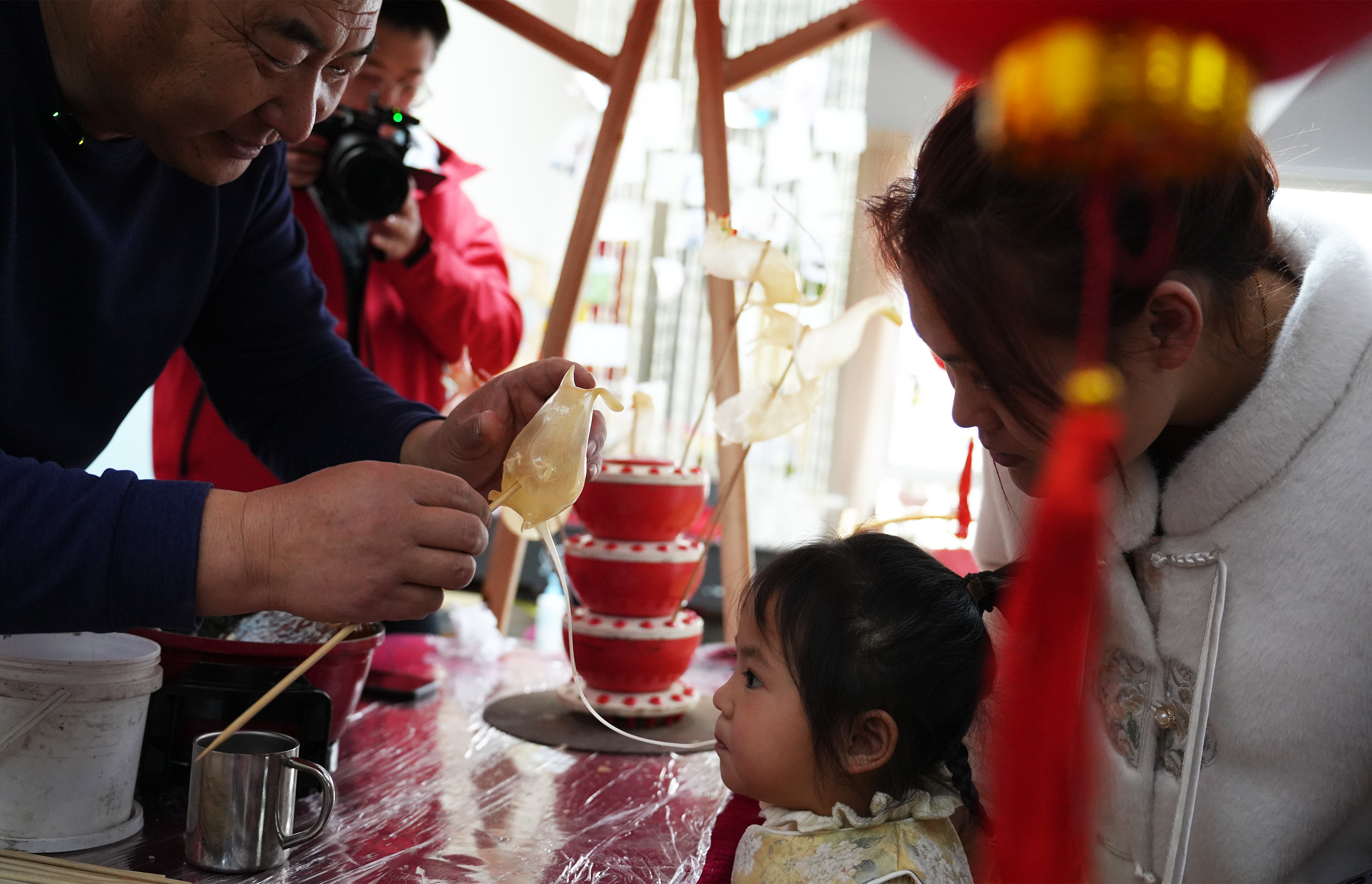 1月28日，宏潤幼兒園親子游園會上，在老藝人指導下孩子學吹糖人。常繼德攝