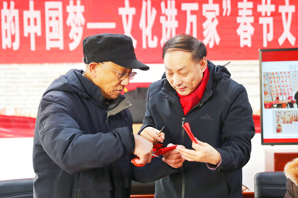 社區居民在創作剪紙作品《馬上有福》。岑屹攝