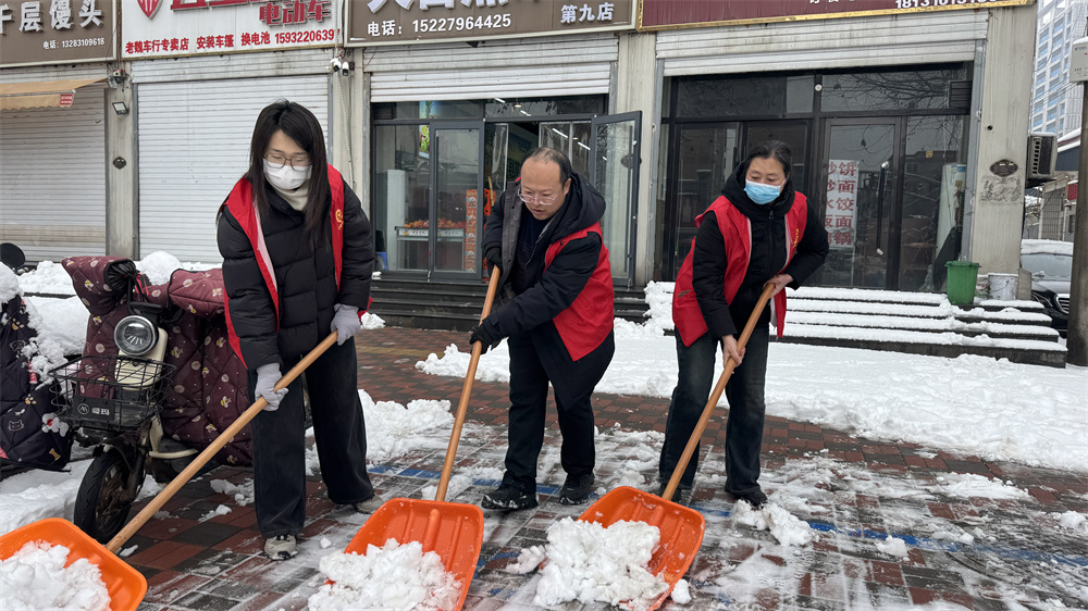志愿者正在铲除便道积雪。冯利轩摄