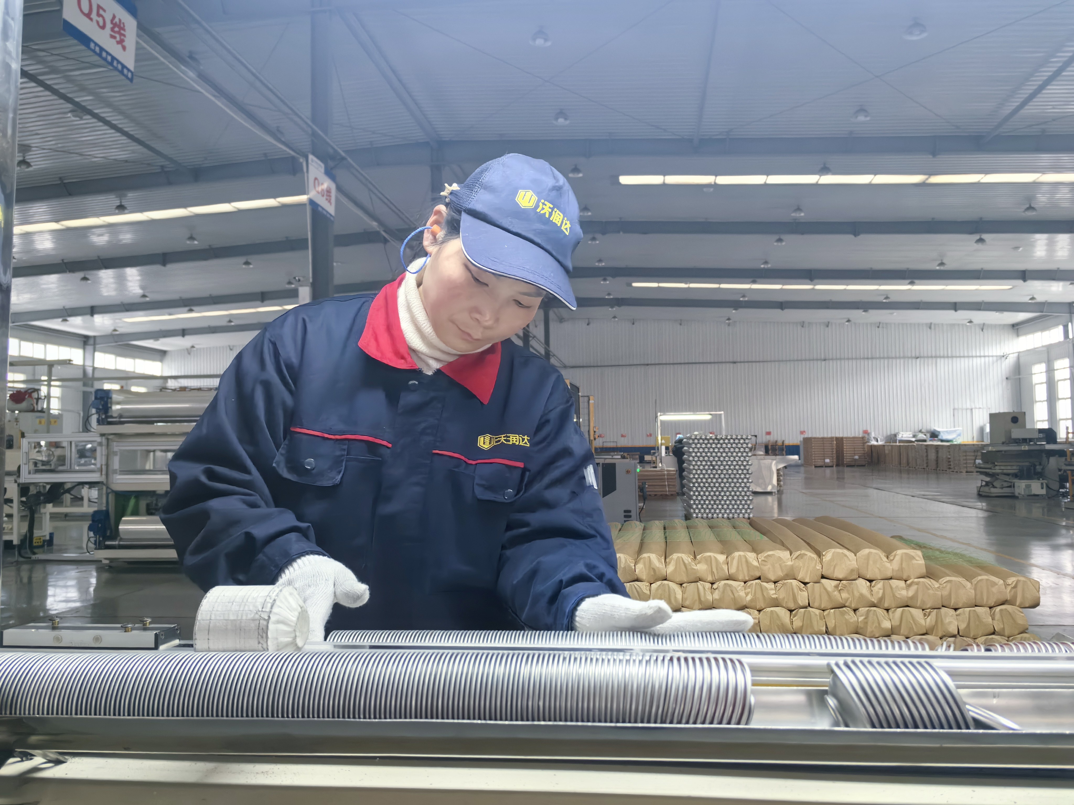 在河北沃潤達金屬包裝制品有限公司生產車間內，工作人員正在對發往法國的產品進行集蓋作業。董亞茹攝