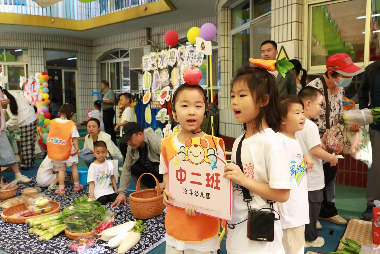 孩子们在快乐果蔬市场推销产品。田博摄