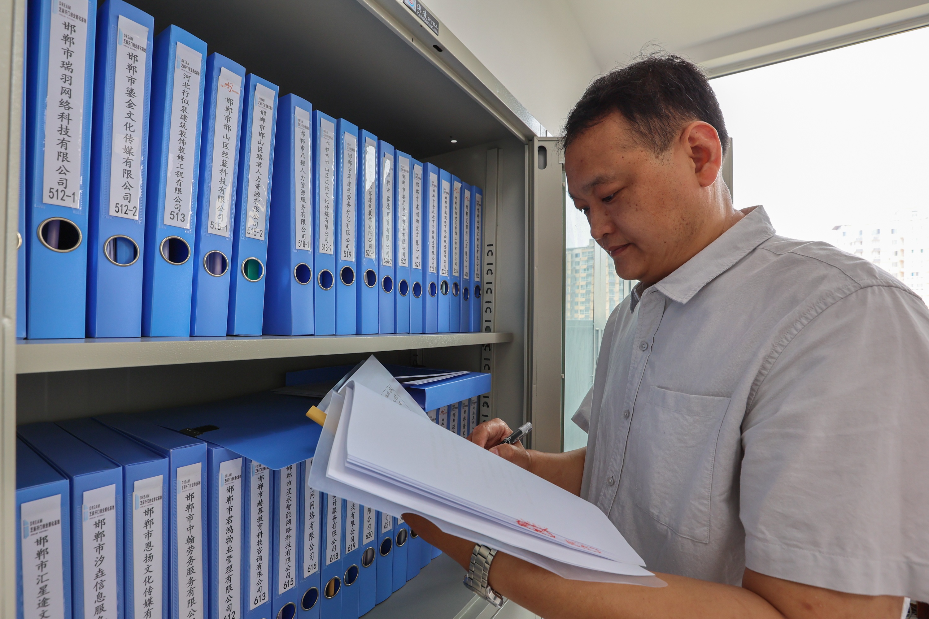 芝麻开门创业孵化基地负责人员正在整理和查看入驻企业资料。李燊摄