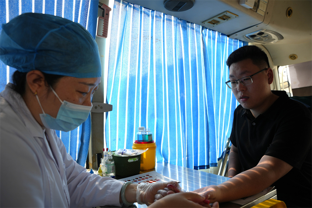 7月27日，河北省隆堯縣醫院獻血車上，獻血人員正在進行血液初篩。張冬茹攝